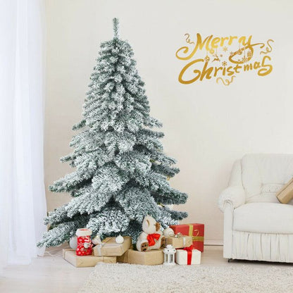 6 foot snow flocked Christmas tree decorated with gifts and teddy bear in cozy living room