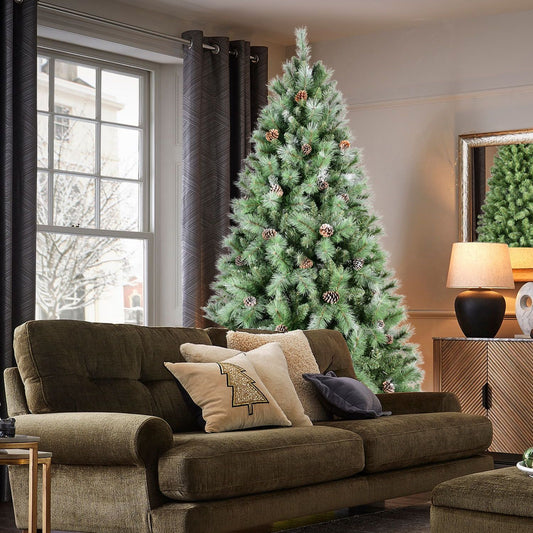 7ft frosted artificial Christmas tree decorated with pine cones in a cozy living room