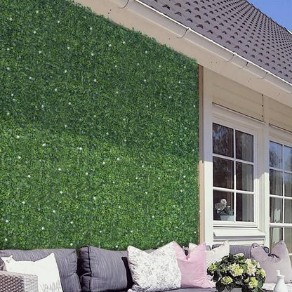 Outdoor wall covered with artificial boxwood hedge panels from FauxMart.com with patio seating area