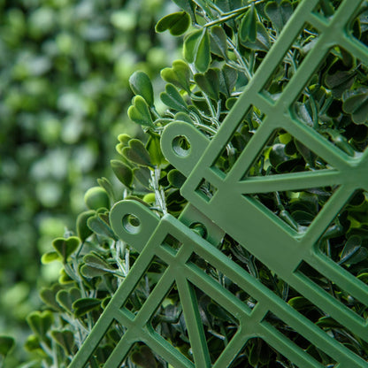 Close-up of green artificial boxwood hedge panels showcasing interlocking design and realistic leaves