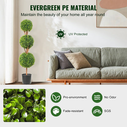 Faux boxwood trees set with three green artificial spheres in black pot placed beside a gray sofa in a modern living room