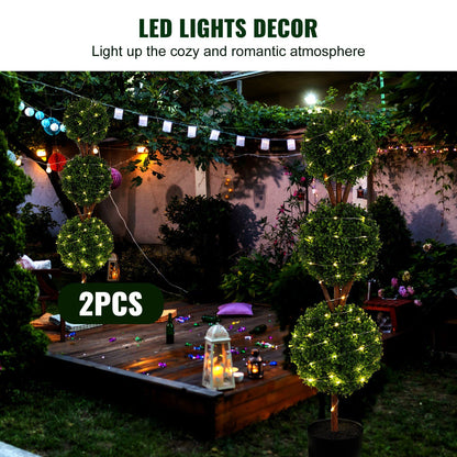 Two faux boxwood trees set with LED lights creating a cozy romantic outdoor atmosphere by FauxMart.com