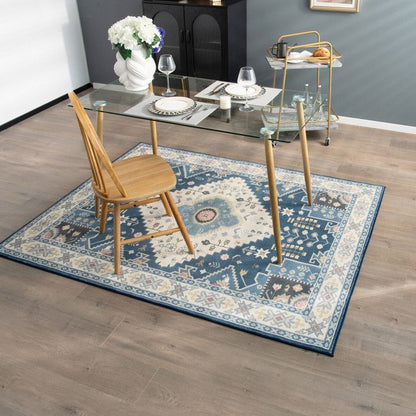 Blue and beige patterned faux wool area rugs under glass dining table with wooden chair