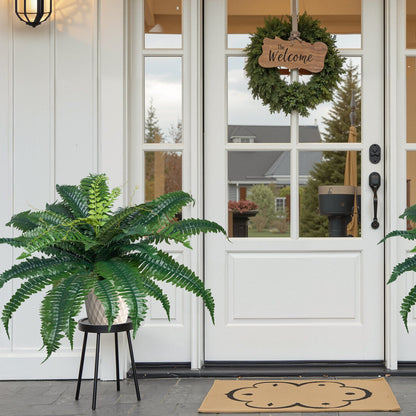 Artificial Boston ferns set displayed in grey pots on black stands near white front door with welcome wreath