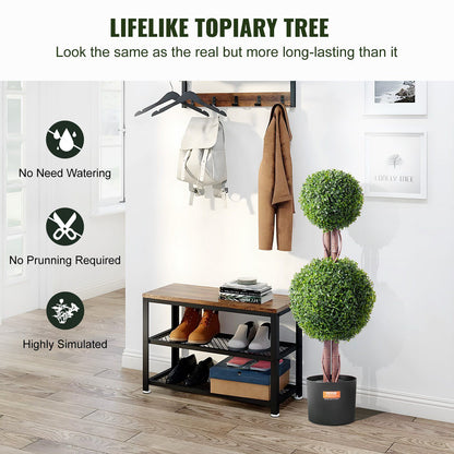 Artificial boxwood topiary tree with two green ball-shaped foliage in a black pot by a shoe rack in a modern entryway