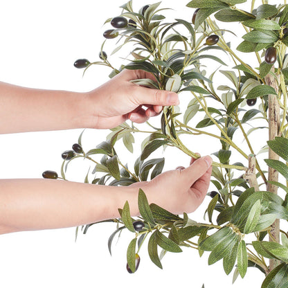 Hands adjusting realistic leaves and olives on artificial olive tree 5ft from FauxMart.com
