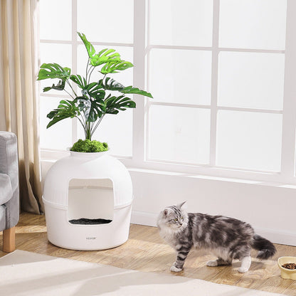 Stylish artificial plant litter box for cats with green foliage, perfect for blending into home decor