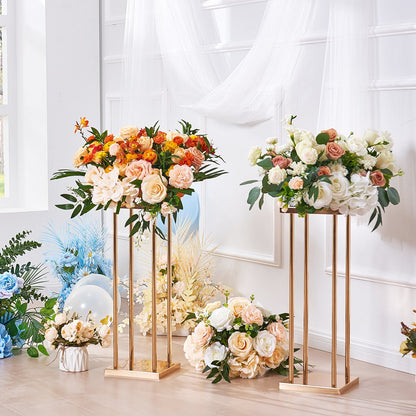 Elegant gold metal wedding flower stands holding colorful and white floral arrangements in a bright room