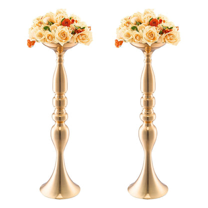 Pair of elegant gold wedding flower stands with cream and orange floral arrangements on top
