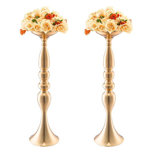 Pair of elegant gold wedding flower stands with cream and orange floral arrangements on top