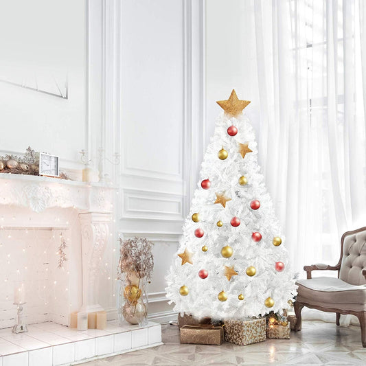 White artificial Christmas tree decorated with gold and red ornaments beside a fireplace in a bright living room